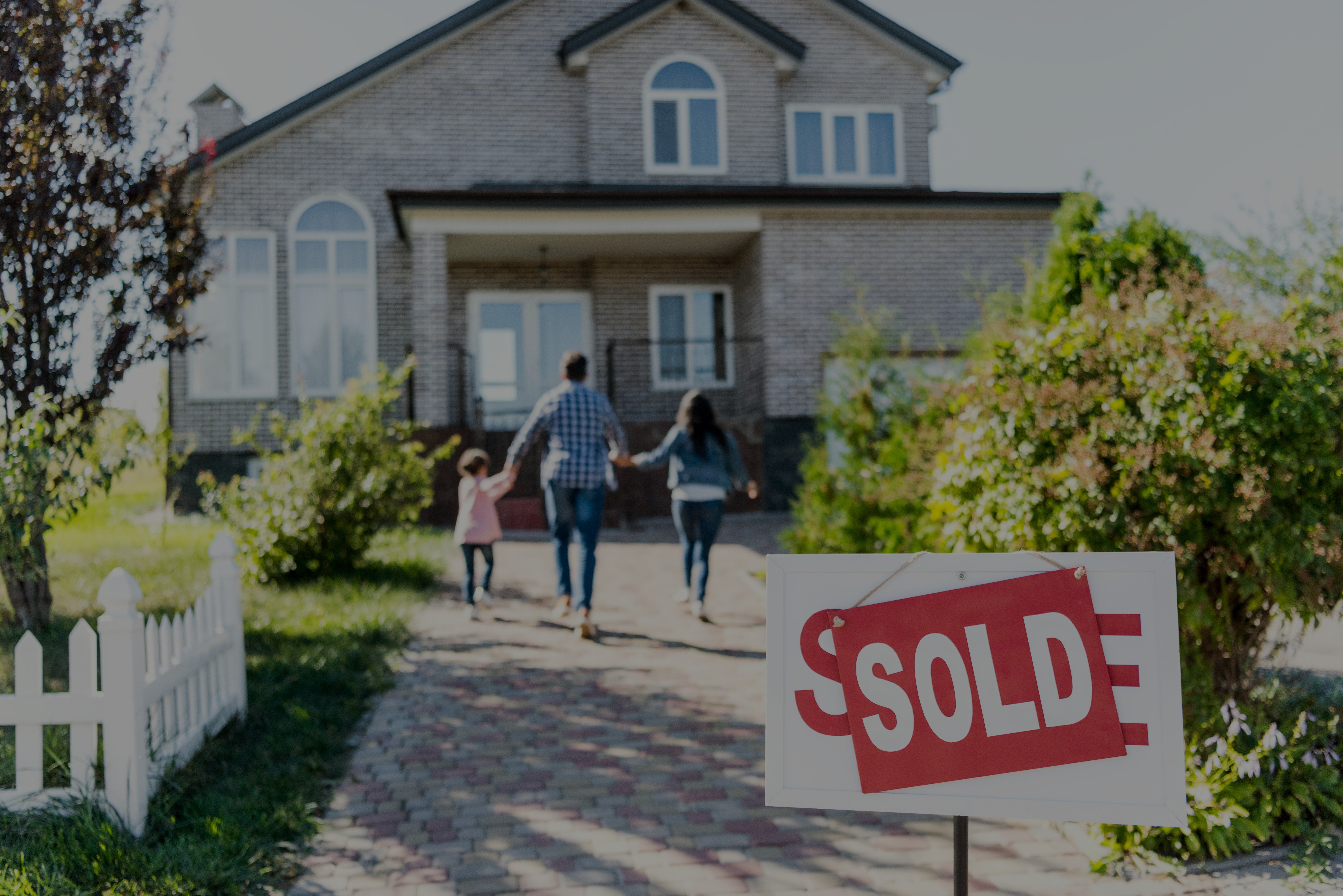 Image of a house and family with a sold sign